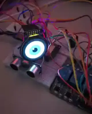 Animated demo of the proximity sensor: the round TFT eye, LEDs, and buzzer escalating as a hand approaches